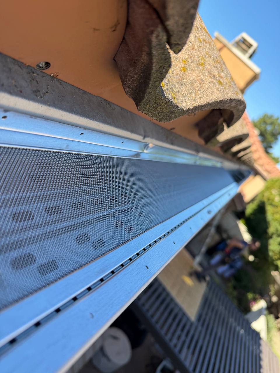 Micro-mesh gutter guard installation protecting from leaves and debris