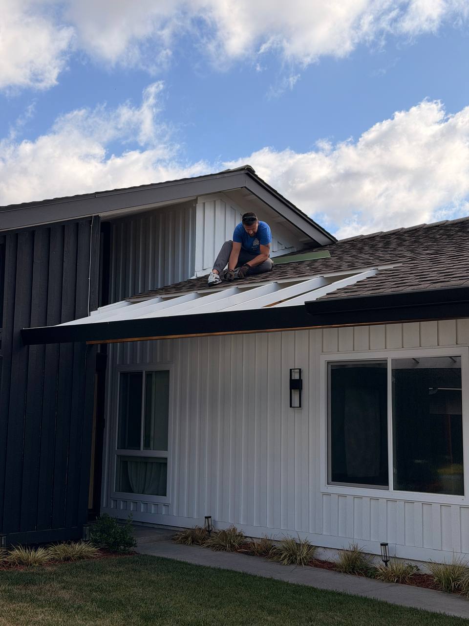 BelFour technician installing seamless gutters on modern California home